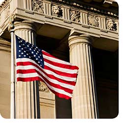 US flag by bank building